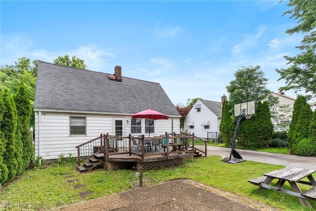 120 Palmetto Ave, Bedford, OH 44146 - back of property featuring a yard, a wooden deck, a chimney, and a shingled roof