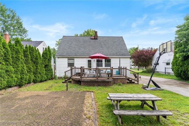 120 Palmetto Ave, Bedford, OH 44146 - back of house featuring a wooden deck, a yard, a chimney, and roof with shingles