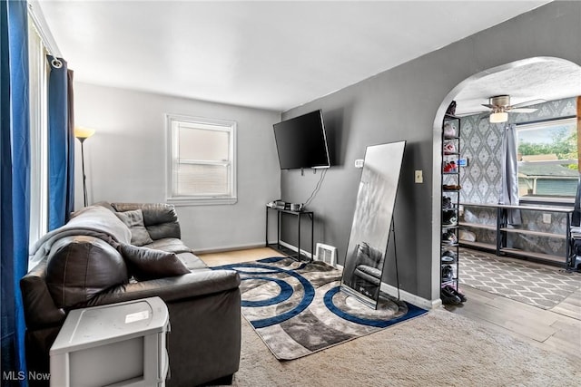 120 Palmetto Ave, Bedford, OH 44146 - living area featuring arched walkways, a ceiling fan, and wood finished floors