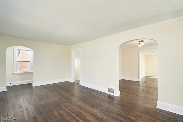2231 16th St, Cuyahoga Falls, OH 44223 - unfurnished room featuring arched walkways, dark wood-style flooring, and crown molding