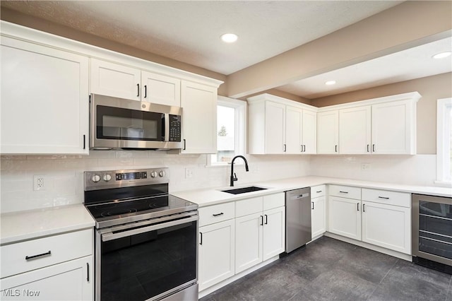 2231 16th St, Cuyahoga Falls, OH 44223 - kitchen with stainless steel appliances, wine cooler, tasteful backsplash, white cabinets, and recessed lighting