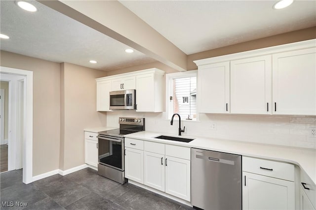 2231 16th St, Cuyahoga Falls, OH 44223 - kitchen featuring stainless steel appliances, recessed lighting, white cabinets, decorative backsplash, and light countertops