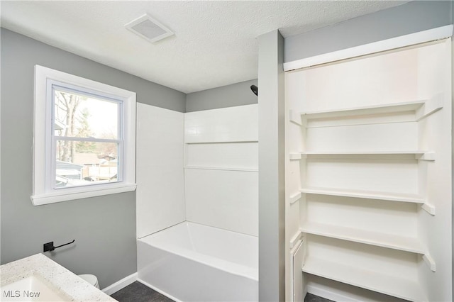 2231 16th St, Cuyahoga Falls, OH 44223 - bathroom with washtub / shower combination, a textured ceiling, and vanity