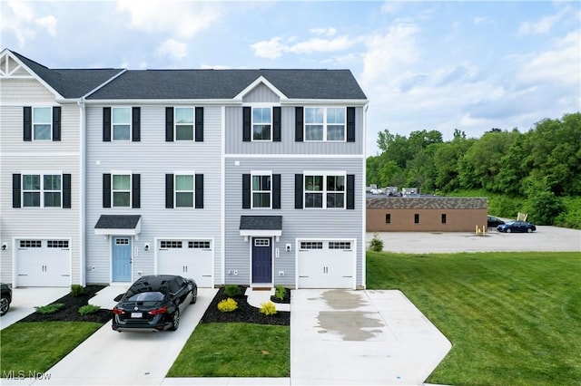393 Slate Rdg, Barberton, OH 44203 - townhome / multi-family property featuring driveway, a front lawn, an attached garage, and a shingled roof