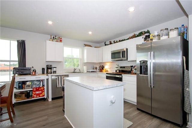 393 Slate Rdg, Barberton, OH 44203 - kitchen with stainless steel appliances, light countertops, wood finished floors, white cabinetry, and recessed lighting
