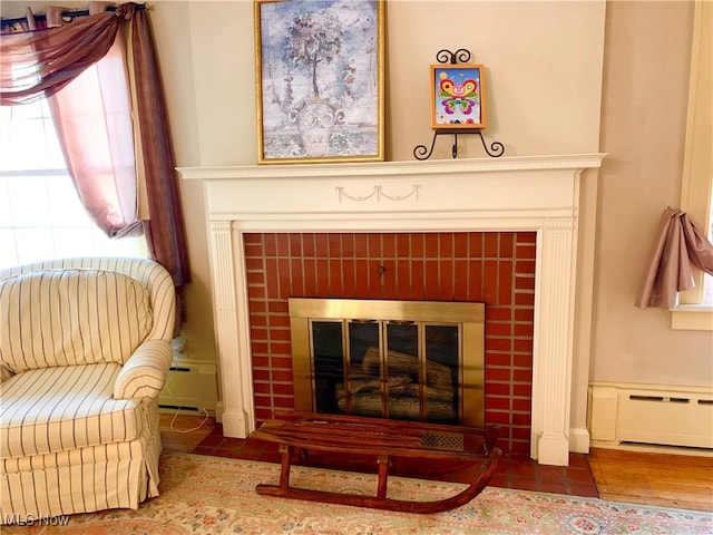 21437 Hillsdale Ave, Fairview Park, OH 44126 - detailed view of a tiled fireplace, baseboard heating, and wood finished floors