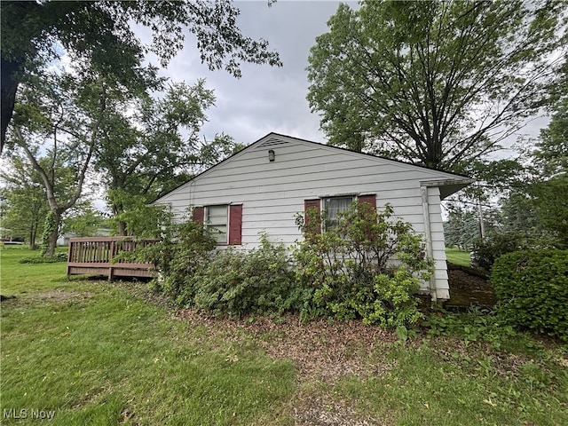 223 Sunset Ct, Columbiana, OH 44408 - view of home's exterior with a wooden deck and a yard
