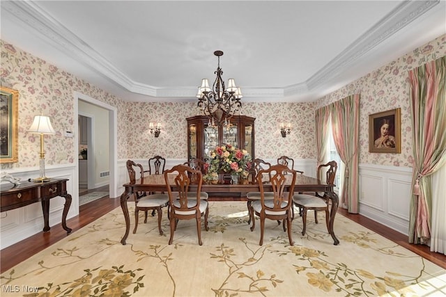23225 Wingedfoot Dr, Westlake, OH 44145 - dining space with a chandelier, wood finished floors, wainscoting, crown molding, and wallpapered walls
