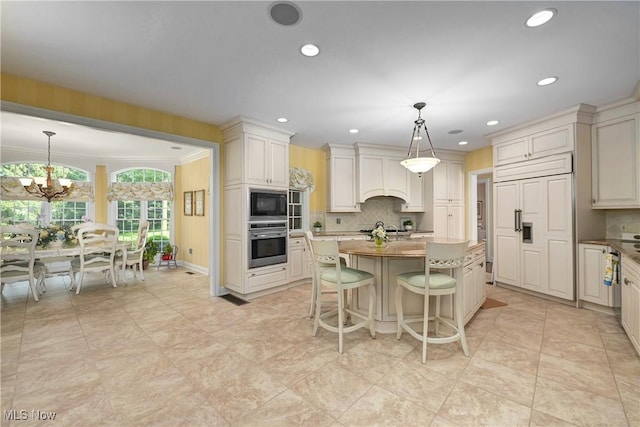 23225 Wingedfoot Dr, Westlake, OH 44145 - kitchen with built in appliances, a center island, backsplash, a chandelier, and recessed lighting