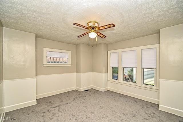 608 Columbus Ave NW, Canton, OH 44708 - unfurnished room featuring a ceiling fan, carpet, and a textured ceiling