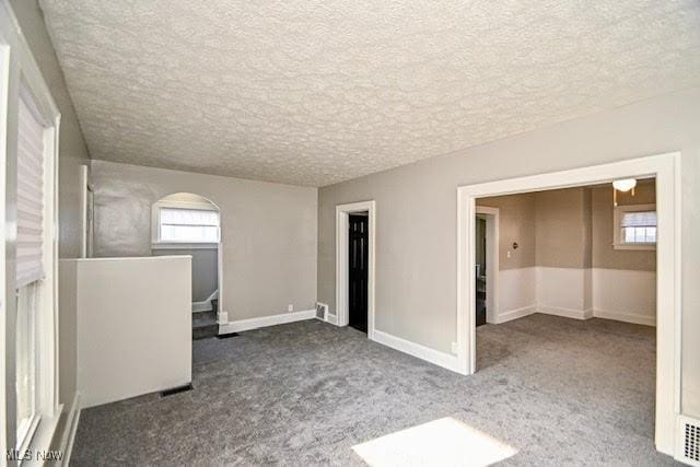 608 Columbus Ave NW, Canton, OH 44708 - carpeted spare room with a textured ceiling and healthy amount of natural light