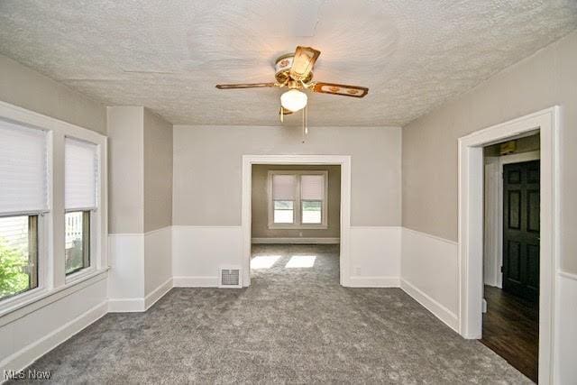 608 Columbus Ave NW, Canton, OH 44708 - carpeted empty room with a textured ceiling and ceiling fan