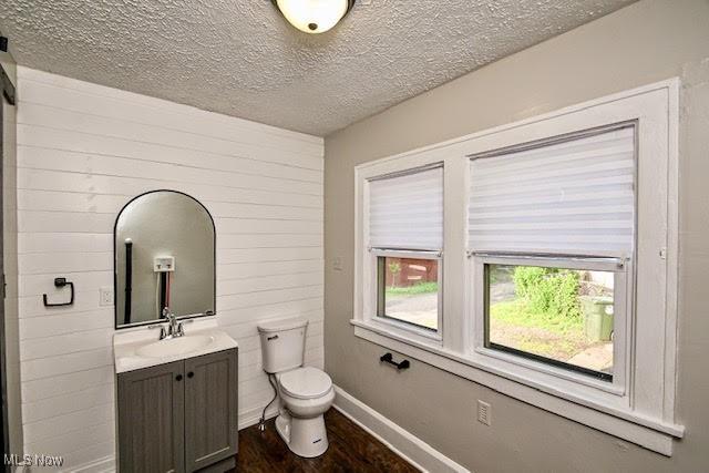 608 Columbus Ave NW, Canton, OH 44708 - bathroom with vanity, wood finished floors, and a textured ceiling