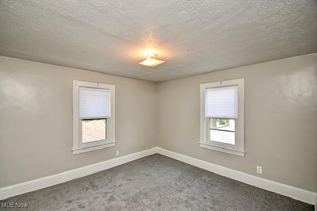608 Columbus Ave NW, Canton, OH 44708 - unfurnished room with a textured ceiling and dark carpet