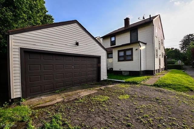 608 Columbus Ave NW, Canton, OH 44708 - rear view of property featuring an outdoor structure, a chimney, and a garage