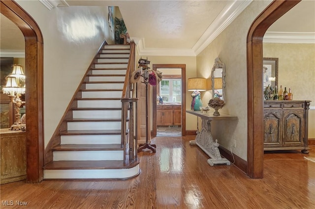 3571 Greenwich Rd, Barberton, OH 44203 - staircase featuring arched walkways, wood finished floors, and ornamental molding