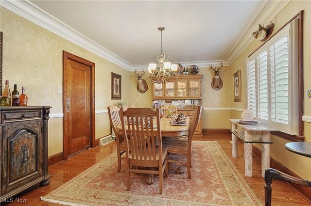 3571 Greenwich Rd, Barberton, OH 44203 - dining area featuring a chandelier, crown molding, and light wood-type flooring