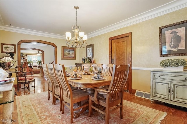 3571 Greenwich Rd, Barberton, OH 44203 - dining room featuring arched walkways, a chandelier, ornamental molding, and wood finished floors