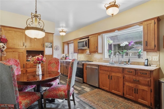 3571 Greenwich Rd, Barberton, OH 44203 - kitchen with appliances with stainless steel finishes, light countertops, backsplash, and decorative light fixtures