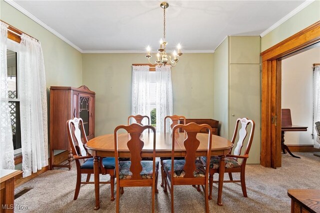 811 E High Ave, New Philadelphia, OH 44663 - dining space featuring a chandelier, crown molding, and light colored carpet