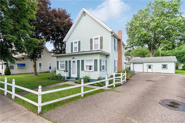 811 E High Ave, New Philadelphia, OH 44663 - view of front of house with a chimney, an outdoor structure, asphalt driveway, and a detached garage