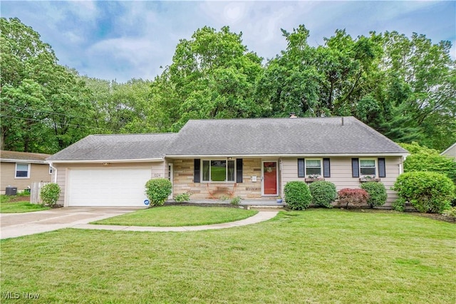 1324 Woodrow St NW, North Canton, OH 44720 - ranch-style home featuring a garage, concrete driveway, and a front yard