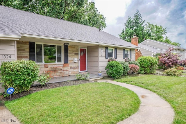 1324 Woodrow St NW, North Canton, OH 44720 - ranch-style home with a porch, stone siding, a front lawn, and roof with shingles