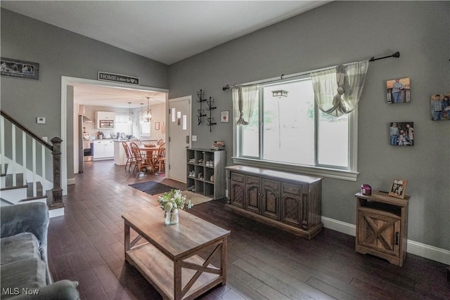 1324 Woodrow St NW, North Canton, OH 44720 - living room featuring dark wood-style flooring, stairs, and vaulted ceiling