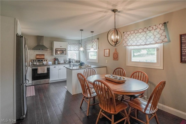 1324 Woodrow St NW, North Canton, OH 44720 - dining space with dark wood-style flooring and a chandelier