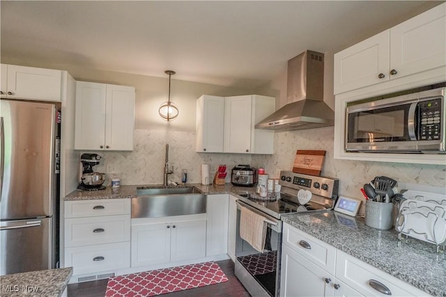 1324 Woodrow St NW, North Canton, OH 44720 - kitchen with wall chimney exhaust hood, appliances with stainless steel finishes, tasteful backsplash, and white cabinets