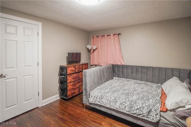 1324 Woodrow St NW, North Canton, OH 44720 - bedroom with wood finished floors and a textured ceiling