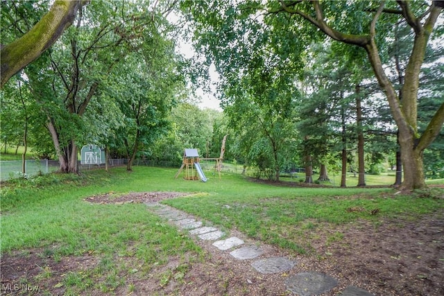 1324 Woodrow St NW, North Canton, OH 44720 - fenced backyard featuring a playground and a storage unit