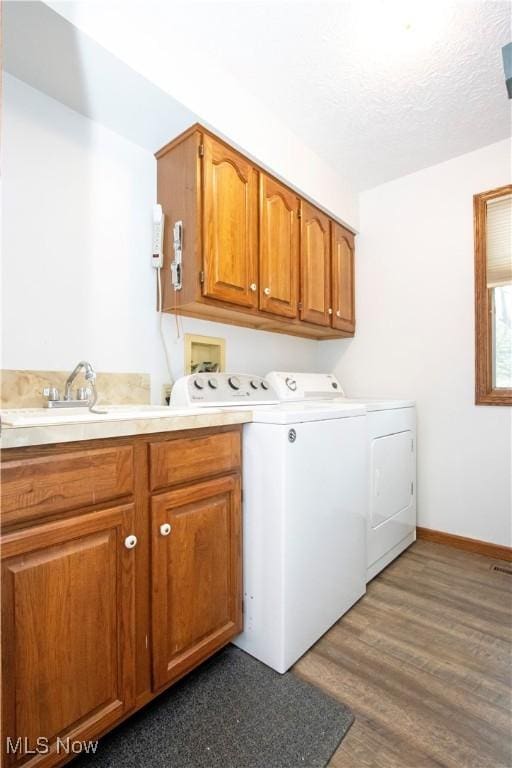13946 Highview Dr, Dalton, OH 44618 - washroom with washer and clothes dryer, cabinet space, dark wood-style floors, and a textured ceiling
