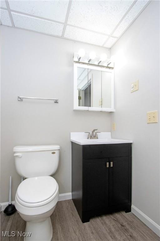13946 Highview Dr, Dalton, OH 44618 - half bathroom featuring wood finished floors, vanity, and a drop ceiling