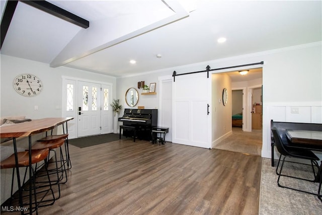 13946 Highview Dr, Dalton, OH 44618 - dining space with a barn door, dark wood-type flooring, beam ceiling, recessed lighting, and ornamental molding