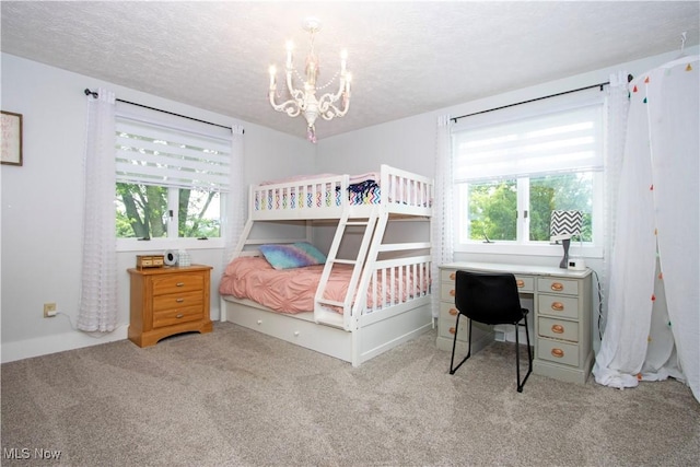 13946 Highview Dr, Dalton, OH 44618 - bedroom with a chandelier, carpet flooring, multiple windows, a textured ceiling, and a desk