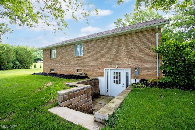 13946 Highview Dr, Dalton, OH 44618 - rear view of house featuring brick siding and a lawn