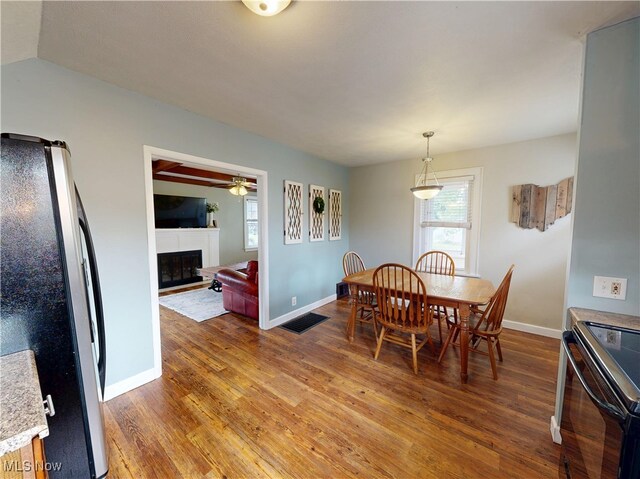 4982 14th St SW, Canton, OH 44710 - dining area with light wood finished floors, a fireplace, and ceiling fan