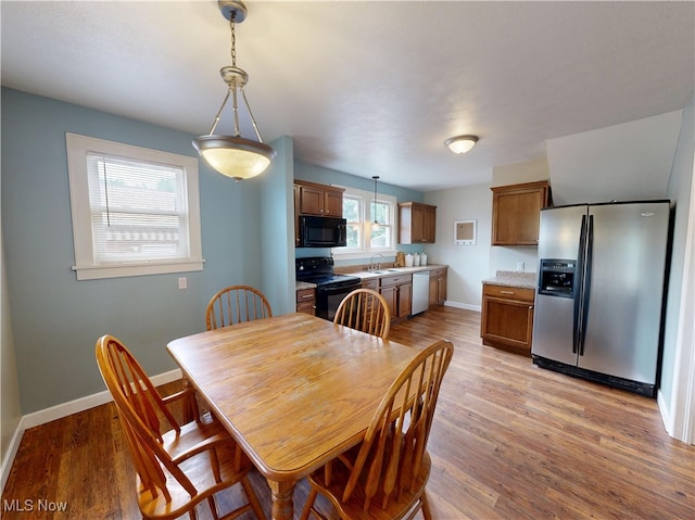 4982 14th St SW, Canton, OH 44710 - dining room featuring light wood-type flooring and baseboards
