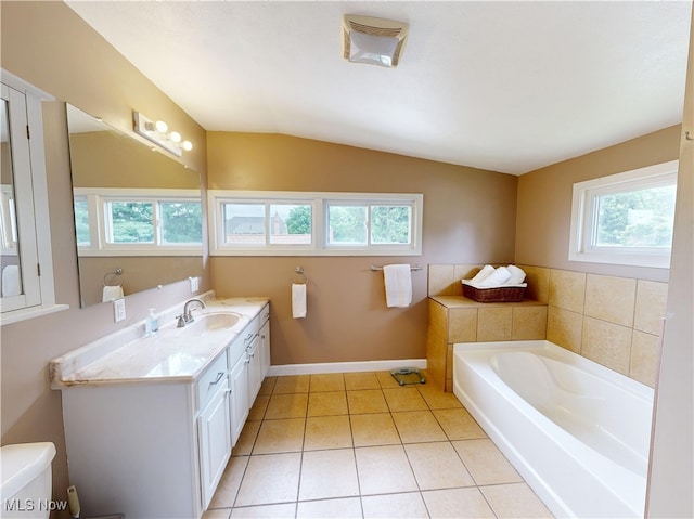 4982 14th St SW, Canton, OH 44710 - bathroom with tile patterned flooring, a bath, vanity, and vaulted ceiling