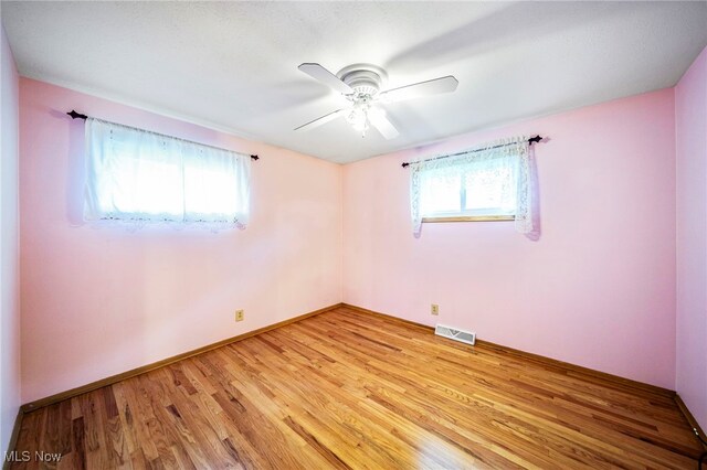 30888 Harrison Rd, Wickliffe, OH 44092 - unfurnished room with healthy amount of natural light, light wood-style floors, and ceiling fan