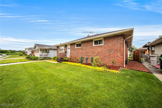 30888 Harrison Rd, Wickliffe, OH 44092 - ranch-style home with a front lawn, brick siding, and covered porch
