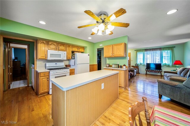 30888 Harrison Rd, Wickliffe, OH 44092 - kitchen with white appliances, open floor plan, light countertops, light wood-style floors, and recessed lighting