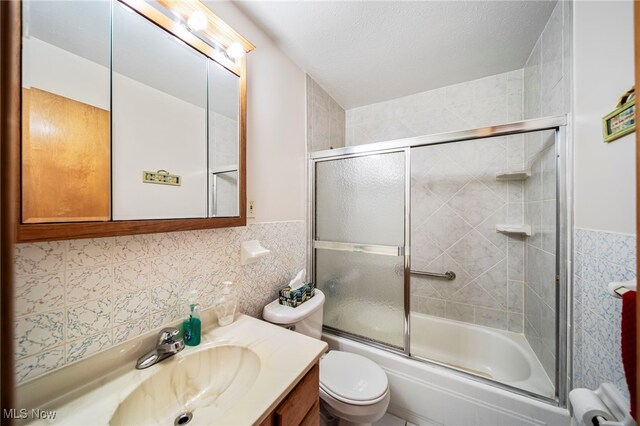 30888 Harrison Rd, Wickliffe, OH 44092 - full bath with tile walls, vanity, and combined bath / shower with glass door