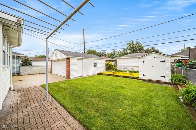 30888 Harrison Rd, Wickliffe, OH 44092 - view of yard featuring an outbuilding, a garage, and a patio