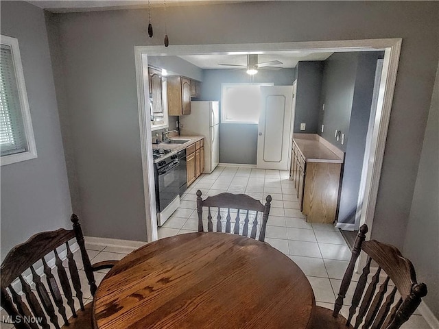 5752 Van Wert Ave, Brook Park, OH 44142 - kitchen with range with gas stovetop, freestanding refrigerator, and light tile patterned floors