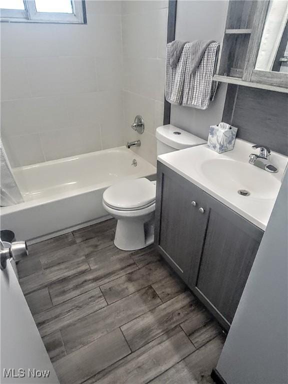 5752 Van Wert Ave, Brook Park, OH 44142 - full bathroom featuring vanity, shower / bathtub combination, and wood finished floors