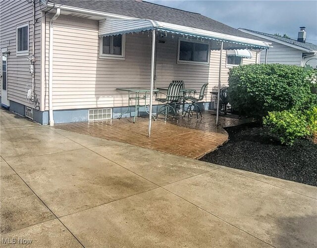 5752 Van Wert Ave, Brook Park, OH 44142 - view of side of property with a patio area and a shingled roof