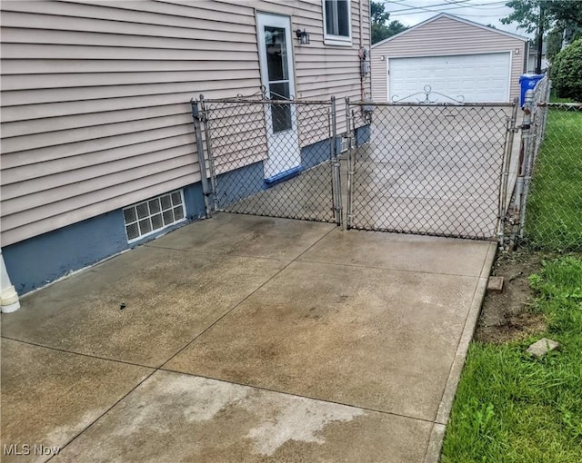 5752 Van Wert Ave, Brook Park, OH 44142 - view of patio with a gate, a garage, and an outbuilding