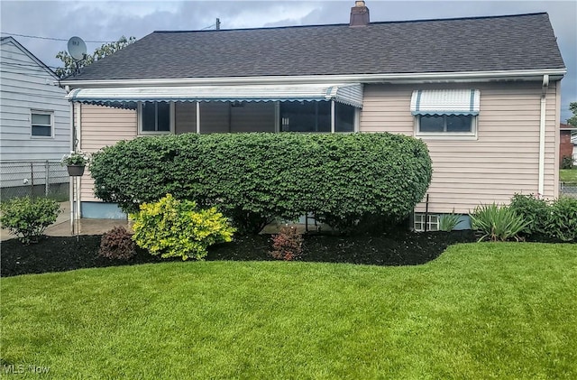 5752 Van Wert Ave, Brook Park, OH 44142 - back of house with a lawn, a shingled roof, and a chimney